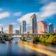 The skyline of downtown Tampa on the Hillsborough river under a blue sky