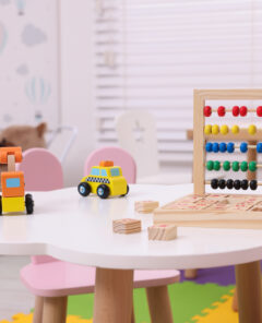 Different toys on table in playroom. Kindergarten interior